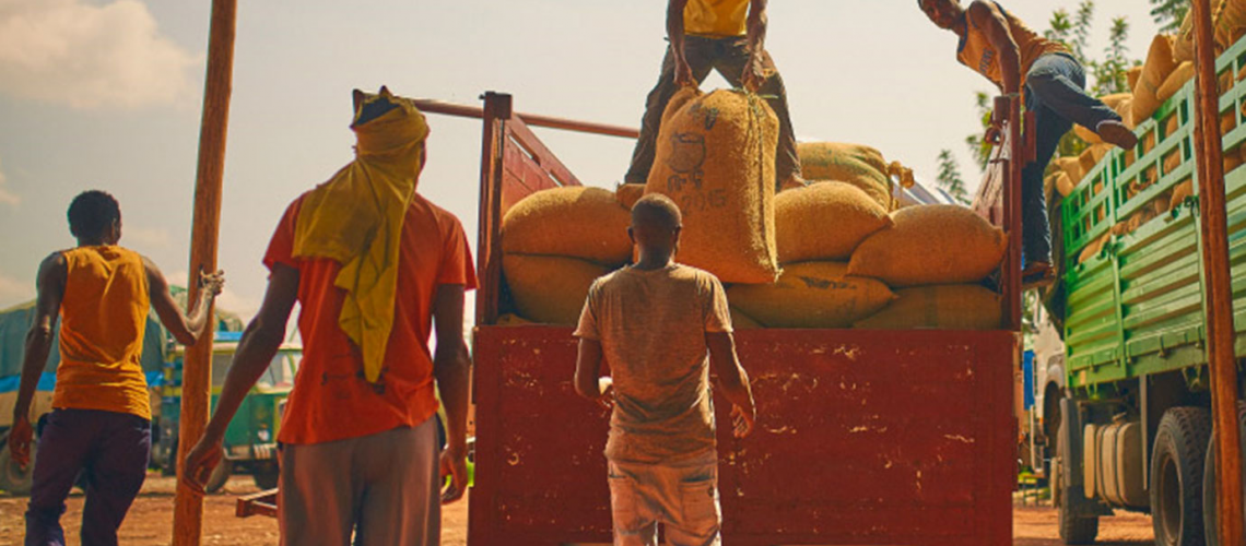 Men moving bags of food off a truck