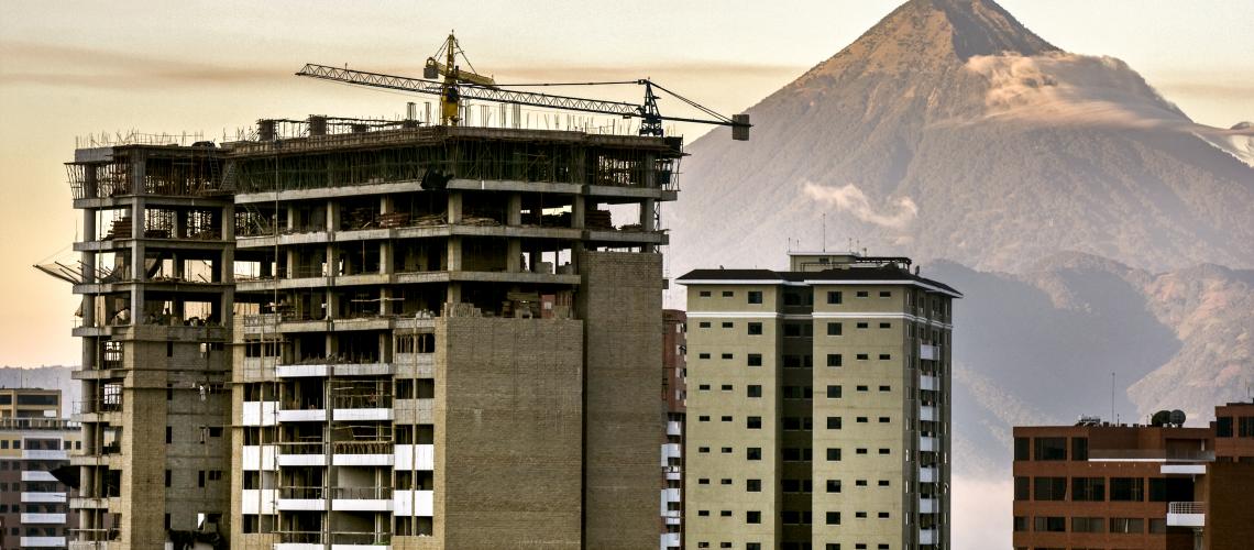 Building of a complex in front of a mountain