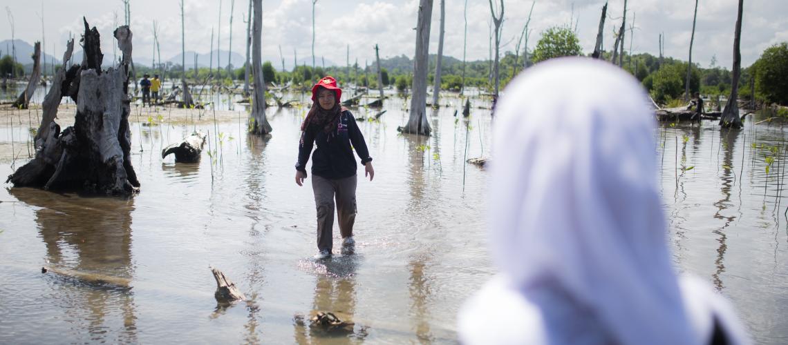 Humanitarian worker walking along flooded area