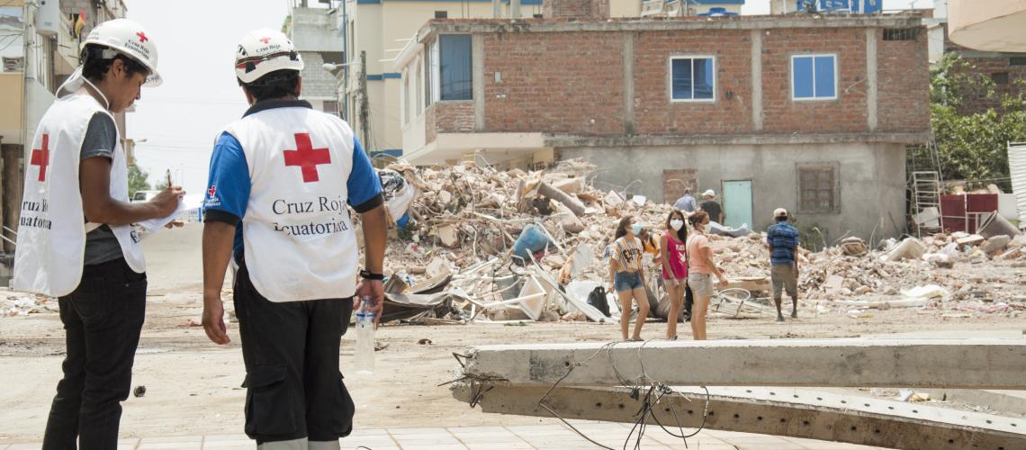 Two Red Cross workers standing on a street