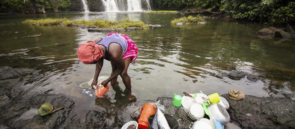 Woman filling containers in the water