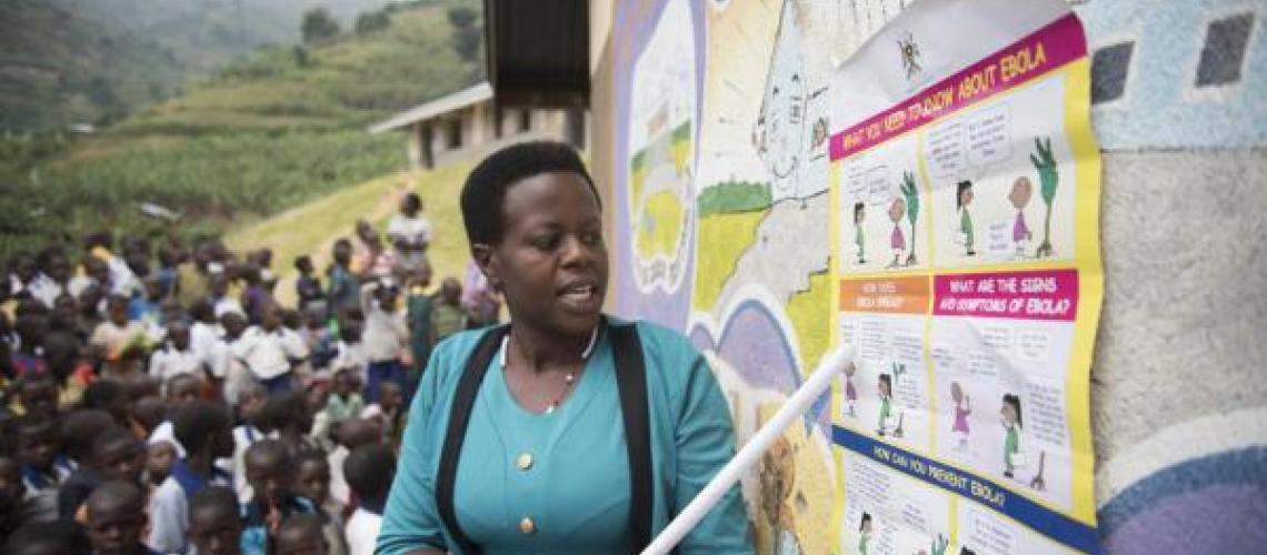 Woman pointing out information on a board