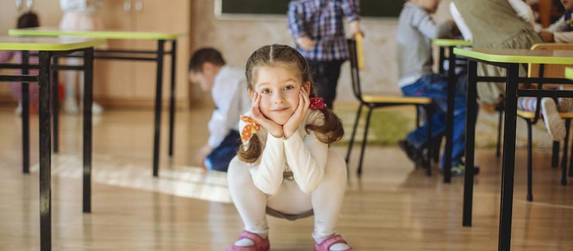 Young kids squatting down with hands under face