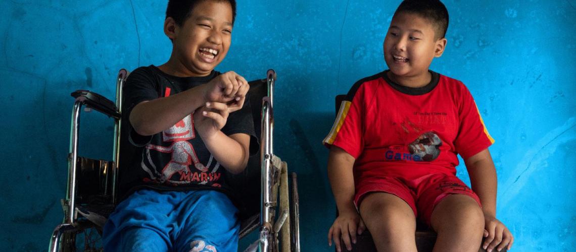 Two young boys in wheelchairs