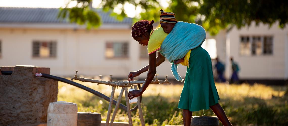 girl filling water from tap