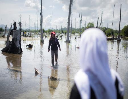 Humanitarian worker walking along flooded area