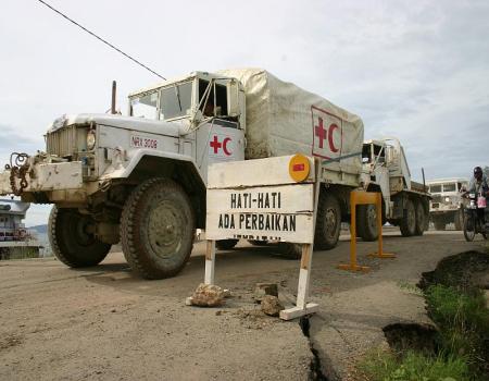 Large truck passing an Indonesian warning sign