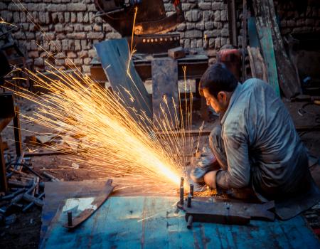 Man using a tool creating sparks