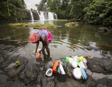 Woman filling containers in the water