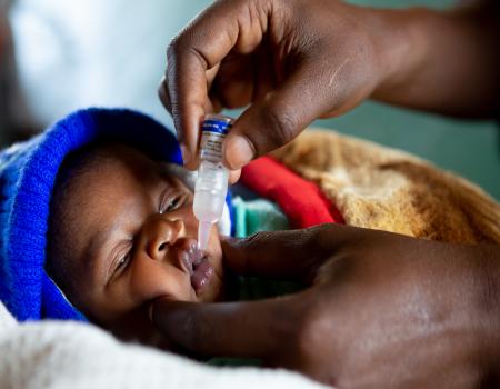 Baby getting administered medicine orally