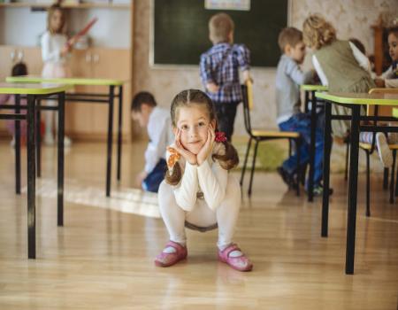 Young kids squatting down with hands under face