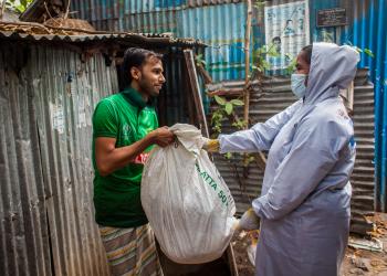 Bangladesh woman helping man